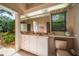 Cozy bathroom featuring a matching pink toilet, sink, and garden view through an open door at 2963 Cielo N Cir, Clearwater, FL 33759