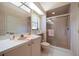 Neutral bathroom featuring a glass enclosed shower, vanity and matching pink fixtures at 2963 Cielo N Cir, Clearwater, FL 33759