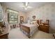 Charming bedroom featuring floral wallpaper, a wood-framed bed, and vintage furnishings at 2963 Cielo N Cir, Clearwater, FL 33759