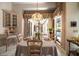 Elegant dining area featuring a unique chandelier, classic decor, and views of the backyard pool at 2963 Cielo N Cir, Clearwater, FL 33759
