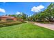 Community entrance with brick signage and manicured greenery leading to a beautiful tree-lined neighborhood at 2963 Cielo N Cir, Clearwater, FL 33759
