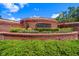 Elysium community entrance featuring brick signage with manicured landscaping and vibrant foliage on a sunny day at 2963 Cielo N Cir, Clearwater, FL 33759