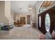 Bright foyer with tile flooring, fireplace, and staircase leading to the second floor at 2963 Cielo N Cir, Clearwater, FL 33759