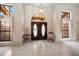 Grand foyer with arched window above double front doors, complemented by tile flooring and natural light at 2963 Cielo N Cir, Clearwater, FL 33759