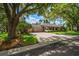 Charming single-story home featuring a well-manicured lawn, mature trees, and a spacious driveway at 2963 Cielo N Cir, Clearwater, FL 33759