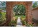Inviting view through brick archway with walkway leading to home in the background at 2963 Cielo N Cir, Clearwater, FL 33759