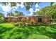 Charming single-story home with lush front lawn and manicured landscaping under a cloudy blue sky at 2963 Cielo N Cir, Clearwater, FL 33759