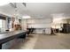 Spacious garage featuring a pool table, ample storage, and a convenient workspace area at 2963 Cielo N Cir, Clearwater, FL 33759