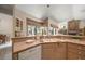 Bright kitchen with a dual sink, wood cabinetry, and seamless integration with the dining area at 2963 Cielo N Cir, Clearwater, FL 33759