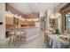 Well-lit kitchen and dining area with vintage cabinets and a center bar, perfect for entertaining at 2963 Cielo N Cir, Clearwater, FL 33759