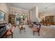 Elegant living area featuring fireplace, dining space, and large windows with a pool view at 2963 Cielo N Cir, Clearwater, FL 33759