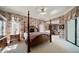 Spacious main bedroom featuring a four-poster bed and a relaxing sitting area at 2963 Cielo N Cir, Clearwater, FL 33759