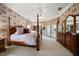 Expansive main bedroom with a four-poster bed, dresser, and access to the lanai at 2963 Cielo N Cir, Clearwater, FL 33759