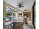 Inviting covered patio with dining furniture overlooking a screened pool and spa with lush landscaping at 2963 Cielo N Cir, Clearwater, FL 33759