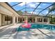 Sparkling screened pool and spa area is surrounded by well-maintained landscaping for privacy and relaxation at 2963 Cielo N Cir, Clearwater, FL 33759