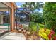 Pool area with landscaping surrounding an inviting screened-in pool area with a hot tub at 2963 Cielo N Cir, Clearwater, FL 33759