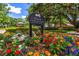 Elysium community sign amidst colorful flowers indicates a deed-restricted and no soliciting neighborhood at 2963 Cielo N Cir, Clearwater, FL 33759