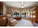 Cozy sitting area with floral wallpaper and view of the pool outside the windows at 2963 Cielo N Cir, Clearwater, FL 33759