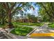 Street view of a well-maintained home with a mature tree canopy and manicured lawn at 2963 Cielo N Cir, Clearwater, FL 33759