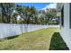 Expansive backyard featuring a well-maintained lawn and a privacy fence, perfect for outdoor activities at 3016 N 73Rd St, Tampa, FL 33619