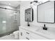 Stylish bathroom featuring a glass-enclosed shower, dual sinks, and modern fixtures at 3016 N 73Rd St, Tampa, FL 33619