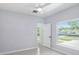 Clean bedroom features a ceiling fan and natural light from the big window at 3016 N 73Rd St, Tampa, FL 33619