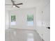 Clean bedroom offers natural light with 2 big windows and a ceiling fan at 3016 N 73Rd St, Tampa, FL 33619
