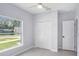 Cozy bedroom features a ceiling fan, closet, and a bright sunny window at 3016 N 73Rd St, Tampa, FL 33619