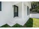 Charming front entrance has a gray door and a matching front light at 3016 N 73Rd St, Tampa, FL 33619