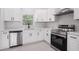 Modern kitchen featuring stainless steel appliances, white cabinets, and sleek countertops at 3016 N 73Rd St, Tampa, FL 33619