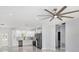 Spacious living area with a ceiling fan and a seamless flow into the adjacent kitchen area at 3016 N 73Rd St, Tampa, FL 33619
