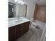 Bathroom featuring a sleek vanity, decorative mirror, and tiled shower-tub combo at 3151 6Th S Ave, St Petersburg, FL 33712