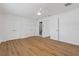 Bedroom featuring hardwood floors, white walls, closet doors and a view to the bathroom at 3151 6Th S Ave, St Petersburg, FL 33712