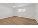 Bright bedroom featuring hardwood floors, white walls, a ceiling fan, and a window at 3151 6Th S Ave, St Petersburg, FL 33712