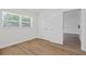 Bright bedroom with hardwood floors, white walls, a window, and closet doors at 3151 6Th S Ave, St Petersburg, FL 33712