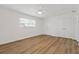 Bright bedroom featuring hardwood floors, white walls, a ceiling fan, and a window at 3151 6Th S Ave, St Petersburg, FL 33712