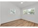 Bedroom with white walls, wood-look floors, and two windows at 3151 6Th S Ave, St Petersburg, FL 33712