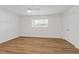 Bedroom with hardwood floors, white walls, ceiling fan, window, and closet at 3151 6Th S Ave, St Petersburg, FL 33712