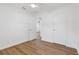 Bedroom with white walls, wood-look floors, and view into another room at 3151 6Th S Ave, St Petersburg, FL 33712