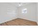 Bedroom with white walls, wood-look floors, a ceiling fan, and a window at 3151 6Th S Ave, St Petersburg, FL 33712