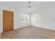 A bedroom with wood-look flooring, light walls, and bright, window-filled natural light at 3151 6Th S Ave, St Petersburg, FL 33712