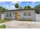 Charming home with a modern front door, well-maintained lawn, and lush landscaping at 3151 6Th S Ave, St Petersburg, FL 33712
