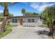 Charming one-story home featuring a newly painted exterior, a minimalist landscape design, and a concrete driveway at 3151 6Th S Ave, St Petersburg, FL 33712