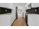 Modern kitchen featuring white cabinets, stainless steel appliances, and black tile backsplash at 3151 6Th S Ave, St Petersburg, FL 33712