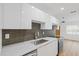Updated kitchen with sleek white cabinets, stainless appliances, and granite countertops at 3151 6Th S Ave, St Petersburg, FL 33712