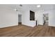 Spacious living room featuring modern lighting, a beverage center, and sleek wood-look flooring at 3151 6Th S Ave, St Petersburg, FL 33712
