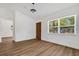 Bright living room featuring windows, hardwood floors, and a wooden door at 3151 6Th S Ave, St Petersburg, FL 33712