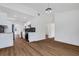 Open concept living space featuring white walls, wood flooring, and a modern kitchen with stainless steel appliances at 3151 6Th S Ave, St Petersburg, FL 33712