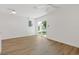 Bright living room with white walls, wood-look floors, and sliding glass doors at 3151 6Th S Ave, St Petersburg, FL 33712