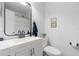 Bathroom with modern sink vanity, decorative mirror, toilet, and a shower with a curtain at 3219 Centerwood Dr, Tarpon Springs, FL 34688